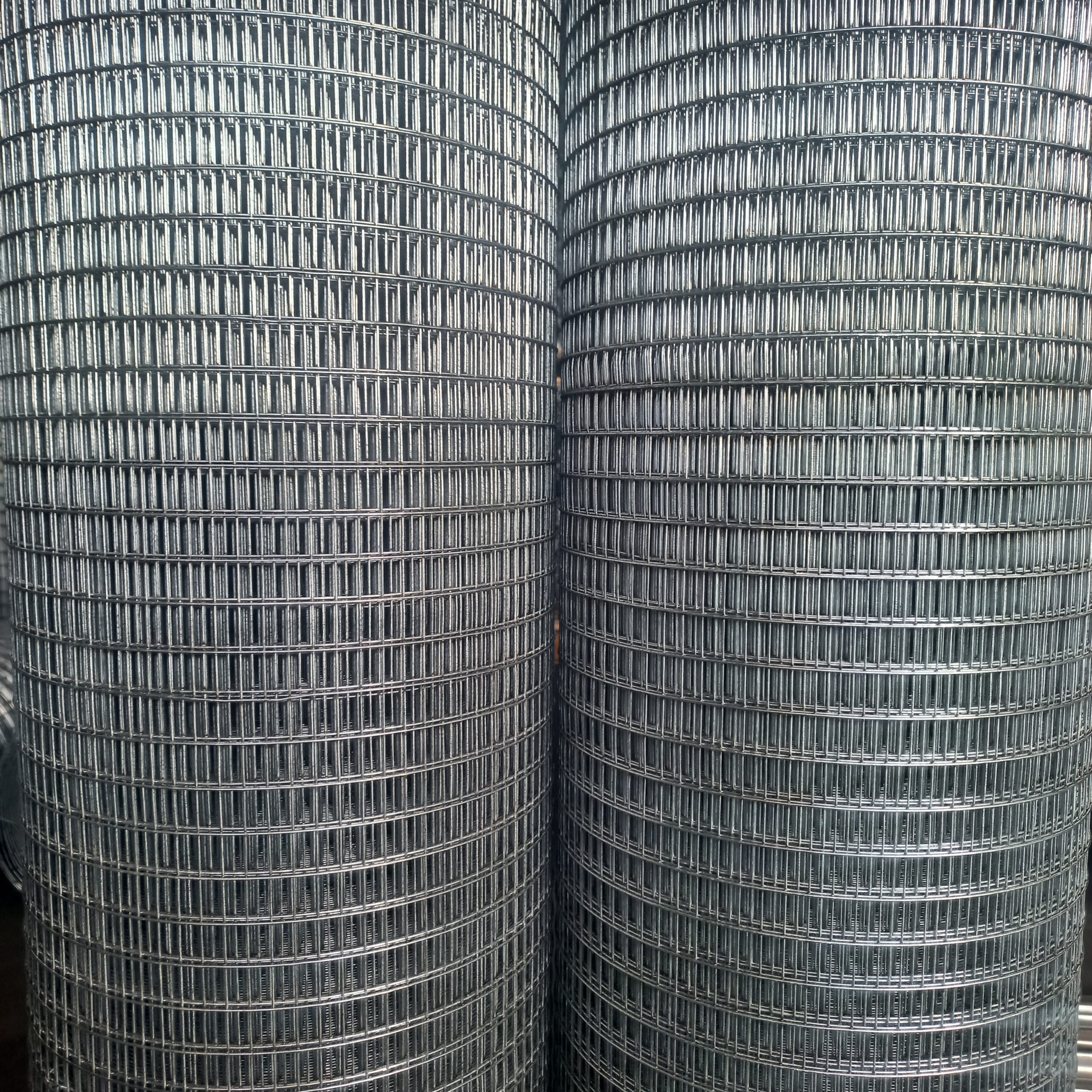 Close-up of galvanized welded mesh rolls with small rectangular openings